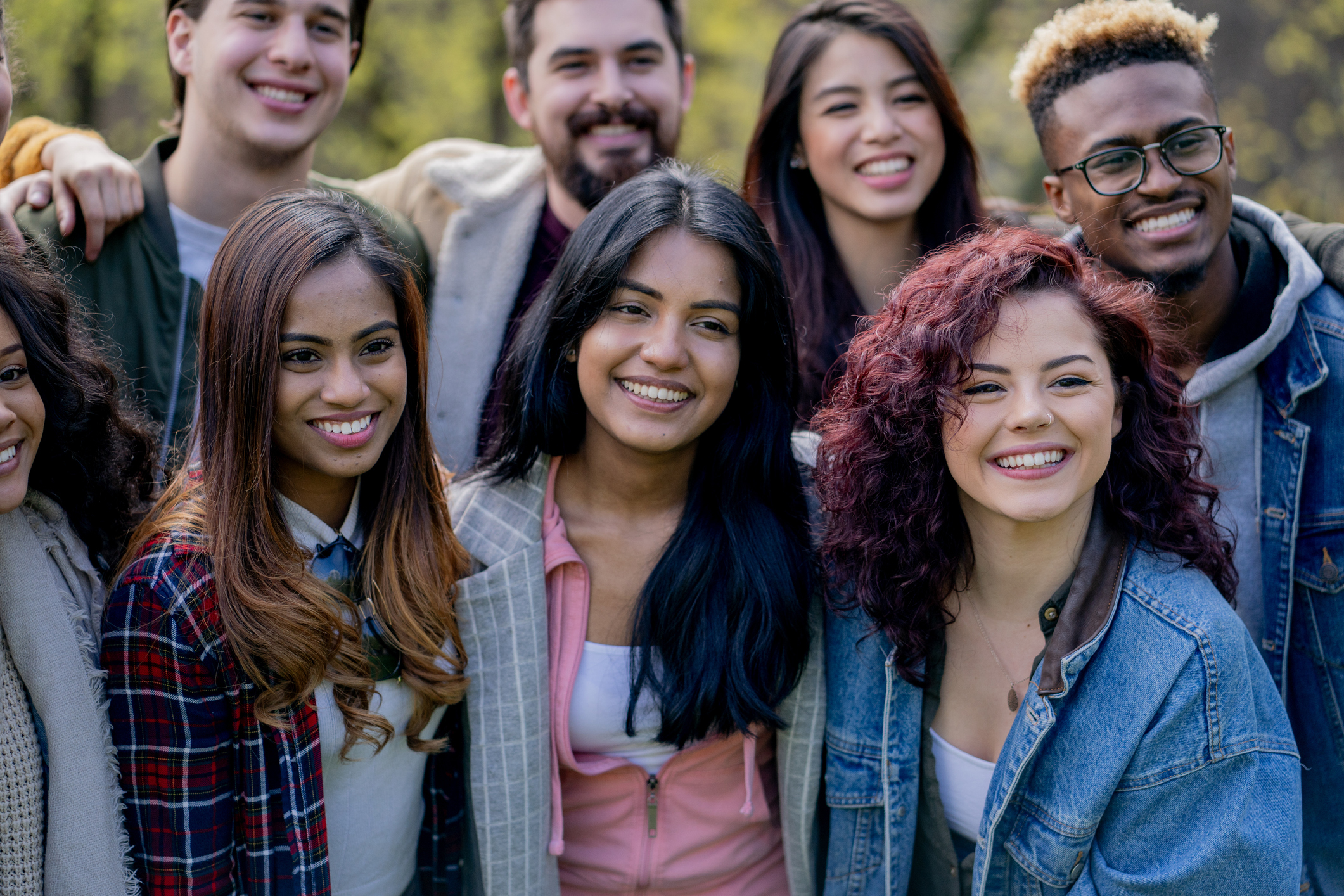 Group of people gathered together looking at the camera